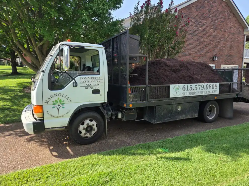 Magnolia's truck loaded with mulch on a customer's driveway